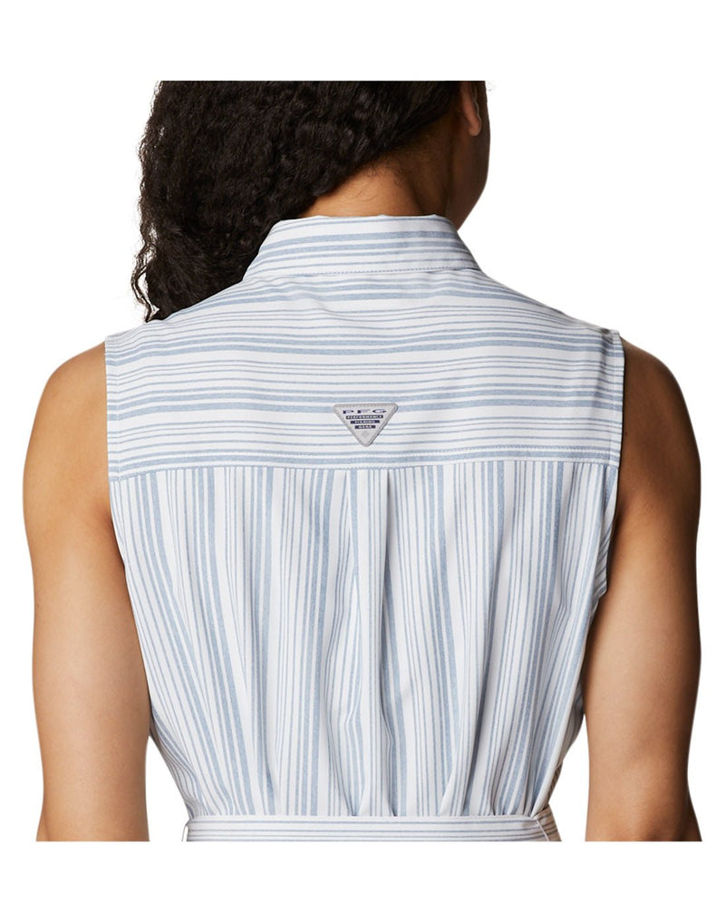 Close up of top half of woman wearing Columbia Women's PFG Sun Drifter™ Woven Dress II in carbon vertical stripe, back view with PFG logo in center of shoulders