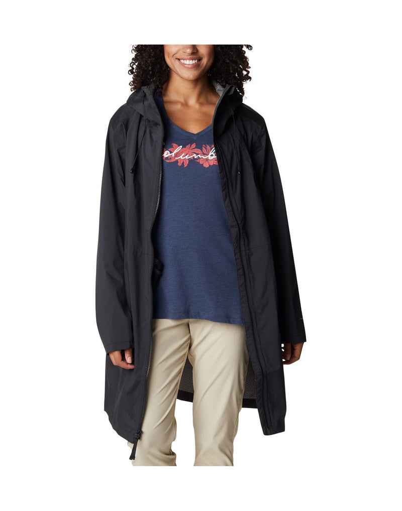 Woman wearing khaki pants, navy graphic shirt, and Columbia Women's Weekend Adventure™ Long Shell Jacket in black, unzipped, front view