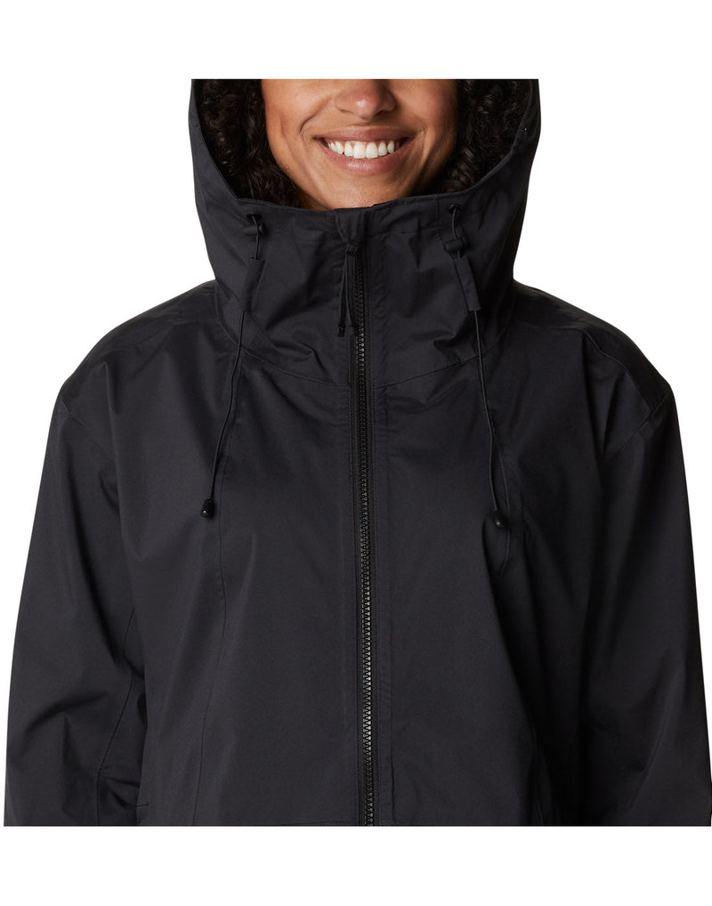 Close up of woman wearing Columbia Women's Weekend Adventure™ Long Shell Jacket in black, hood up, front view