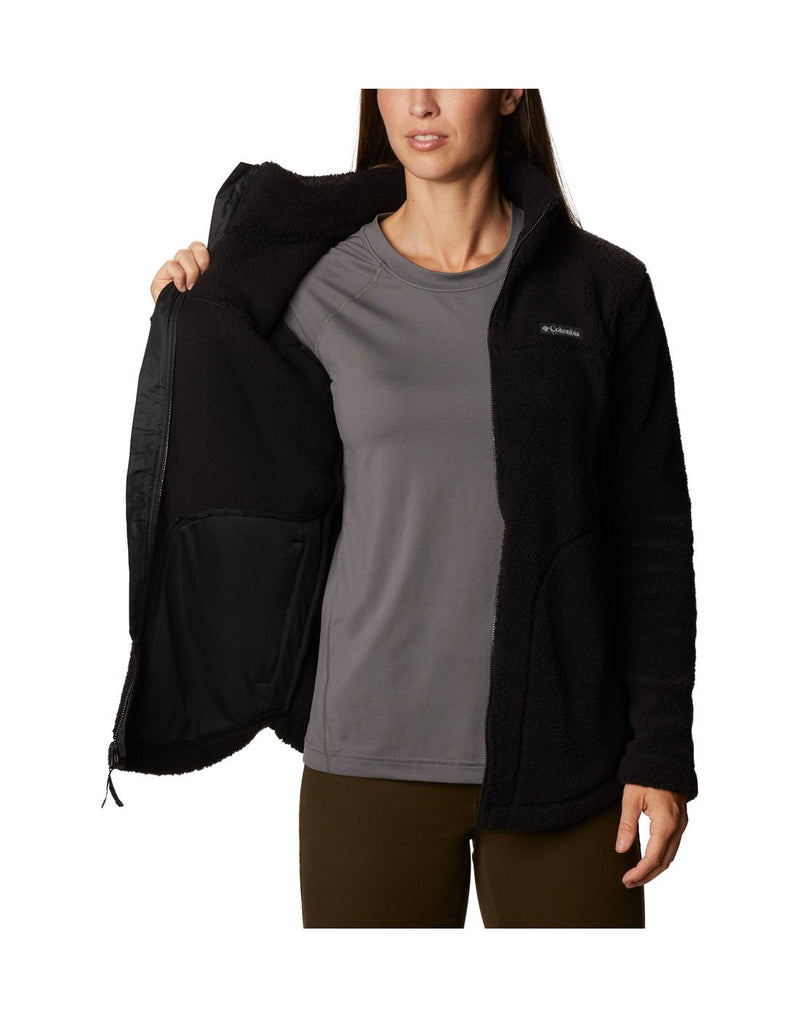 Woman wearing Columbia Women's West Bend™ Full Zip Fleece Jacket in black, front view, unzipped showing inside view of jacket.