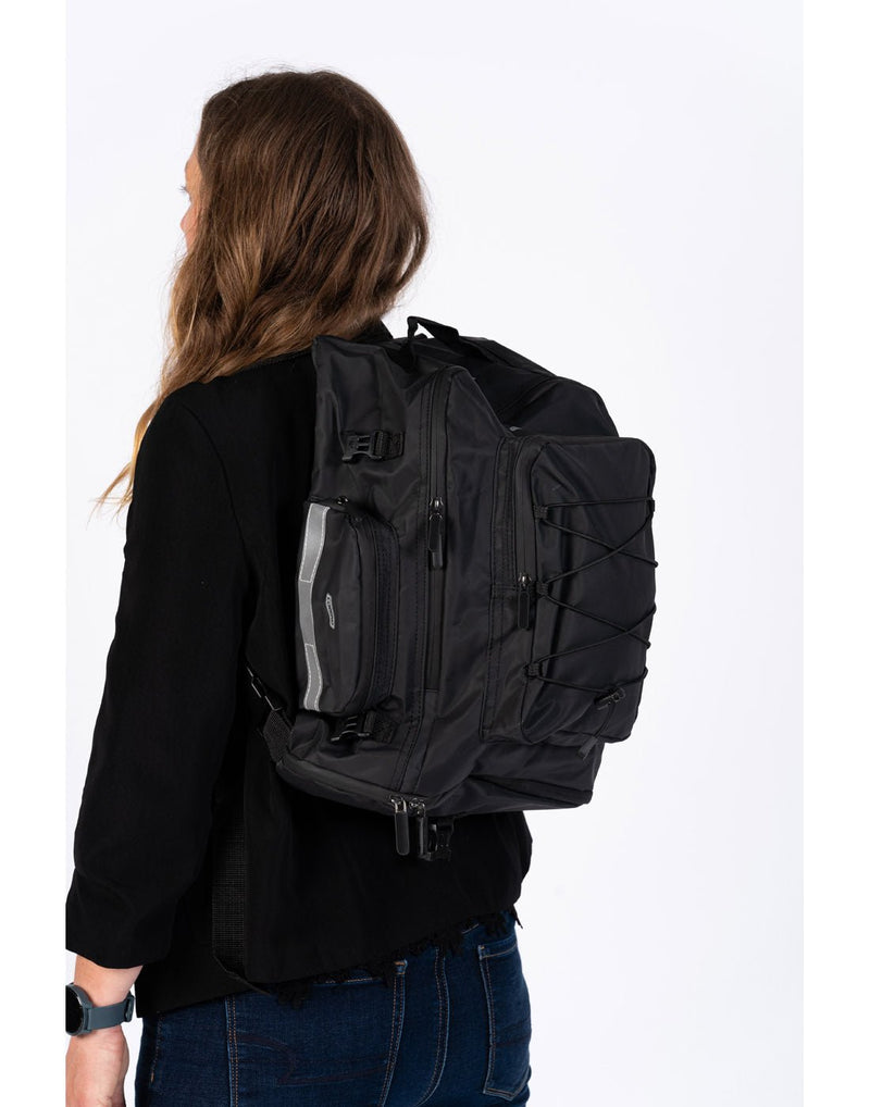 Model wearing black Corsino Discover 3-in-1 Pannier Bag converted to backpack