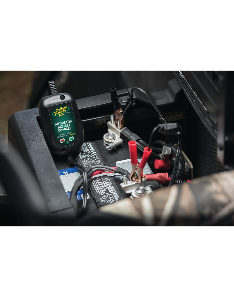 Deltran Weatherproof Battery Tender in use, attached to a car battery