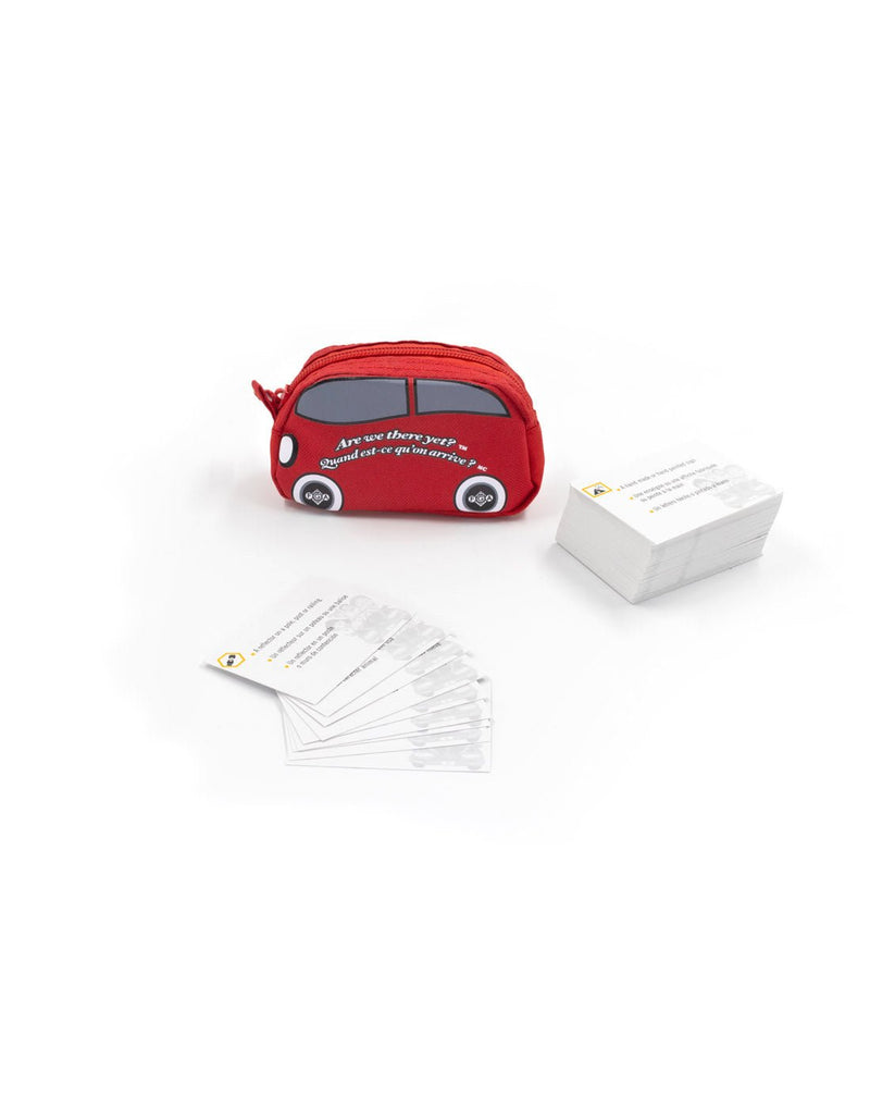 Small red zippered pouch in the shape of a car with a deck of cards stacked beside and a few cards fanned out in front