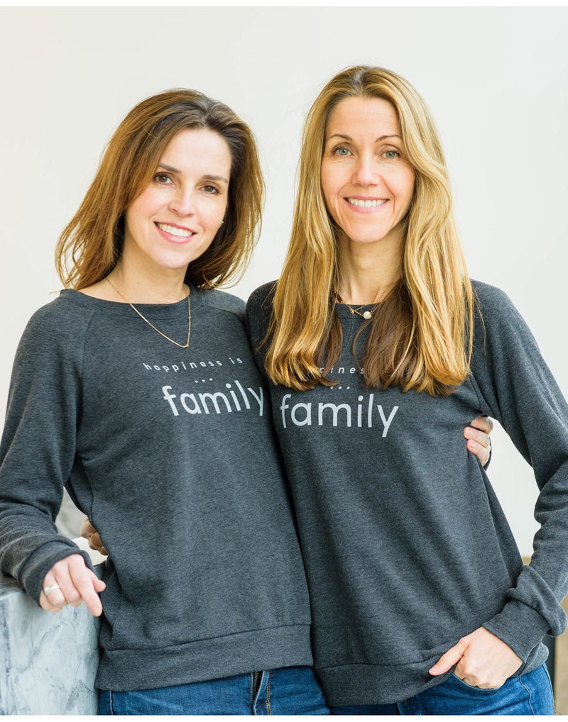 Two women wearing blue jeans and Happiness Is...Family Women's Crew Sweatshirts in charcoal standing arm in arm