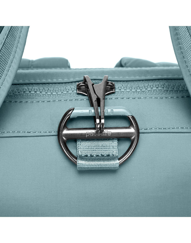 Close up of lockable zipper pulls clipped on front of fresh mint backpack