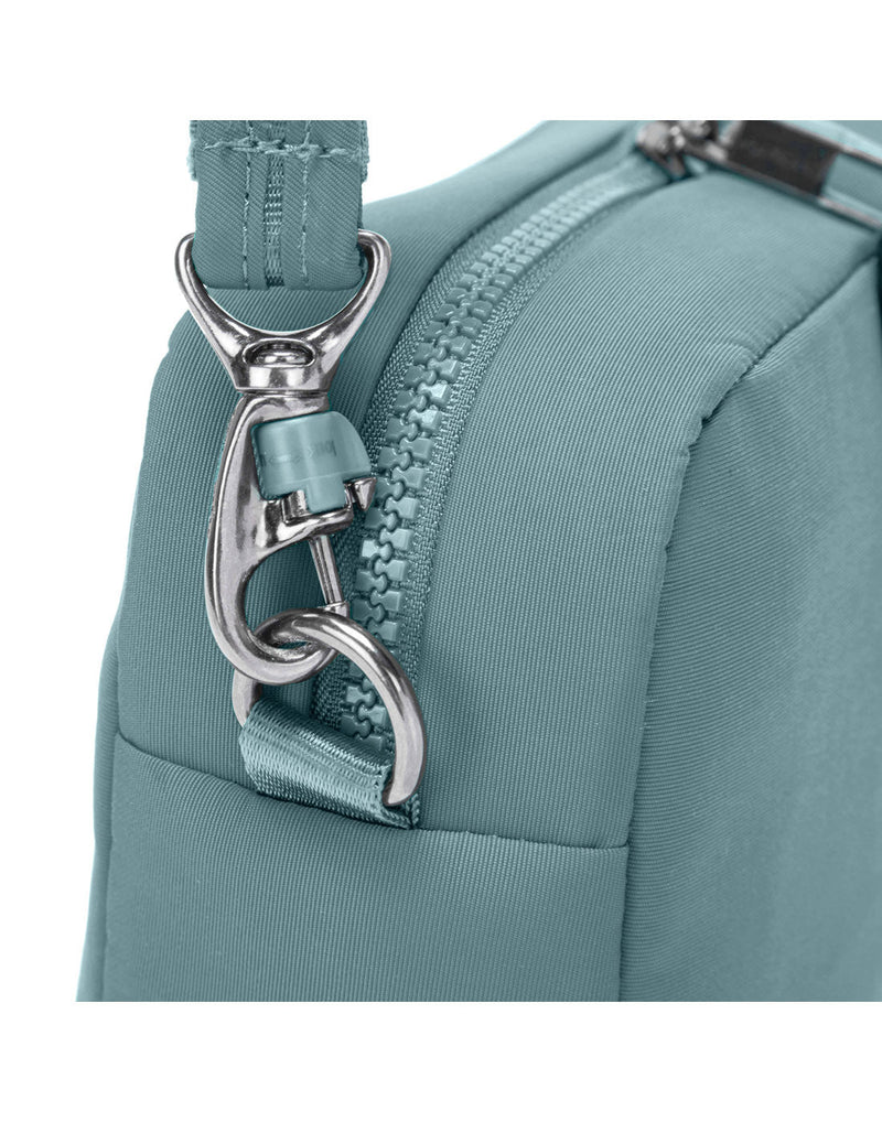 Close up of TurnNLock strap clip on fresh mint Pacsafe® CX Anti-theft Square Crossbody