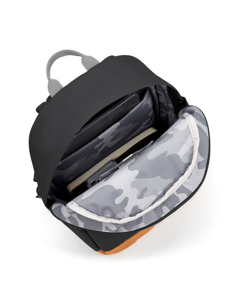 Pacsafe® Go 15L Anti-theft Backpack, jet black with tan bottom gusset unzipped showing the interior of the bag. 