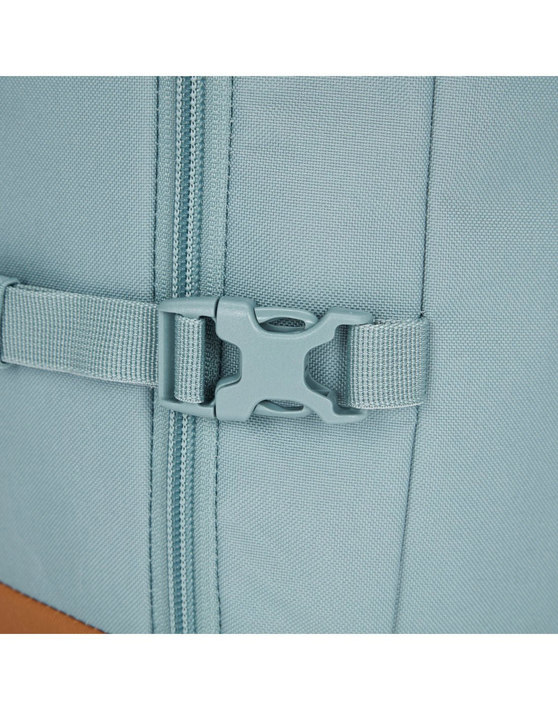 Close-up of an external compression strap that secures and stabilizes backpack contents.