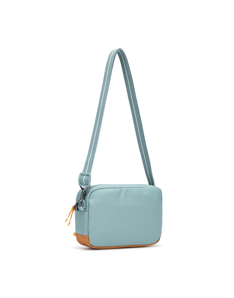 Pacsafe® GO Anti-Theft Crossbody Bag in fresh mint colour back view with Carrysafe® slashguard strap extended.