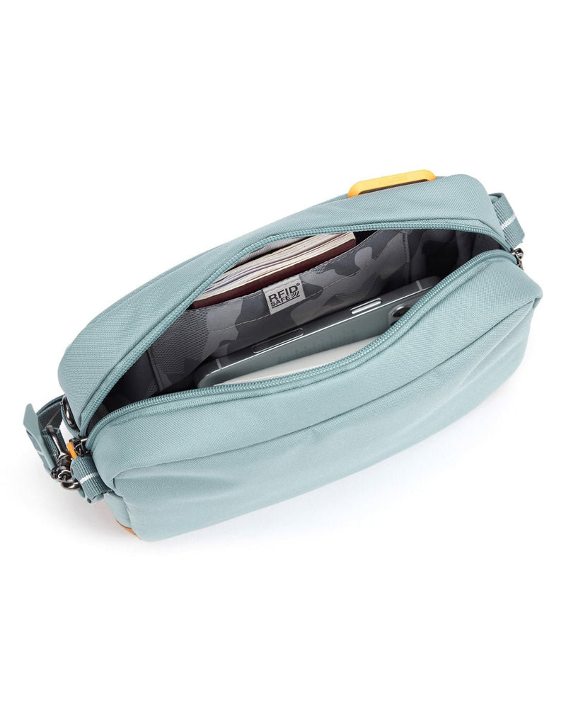 Pacsafe® GO Anti-Theft Crossbody Bag in fresh mint colour showing interior with a RFID blocking pocket.