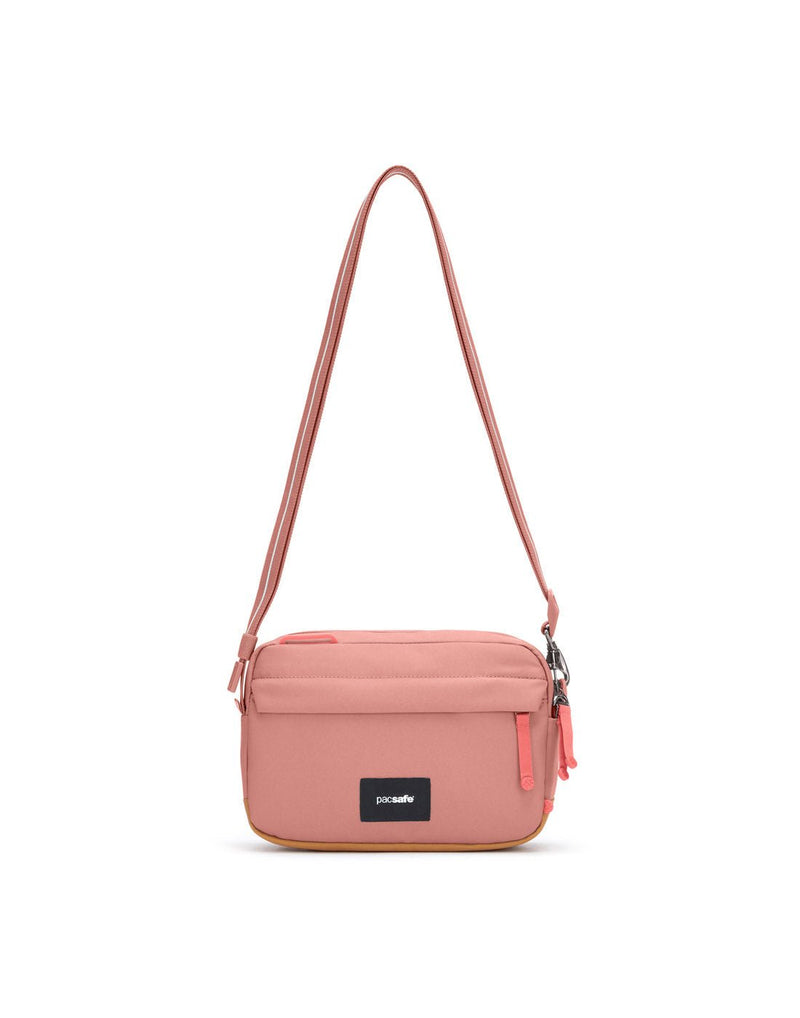 Pacsafe® GO Anti-Theft Crossbody Bag in rose colour front view with Carrysafe® slashguard strap extended.