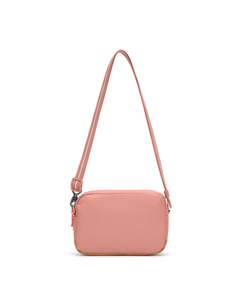 Pacsafe® GO Anti-Theft Crossbody Bag in rose colour back view with Carrysafe® slashguard strap extended.