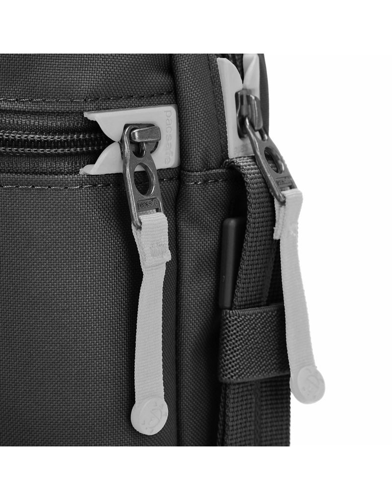 Pacsafe® GO Anti-Theft Festival Crossbody in jet black colour close-up of two zippers with dock locks.