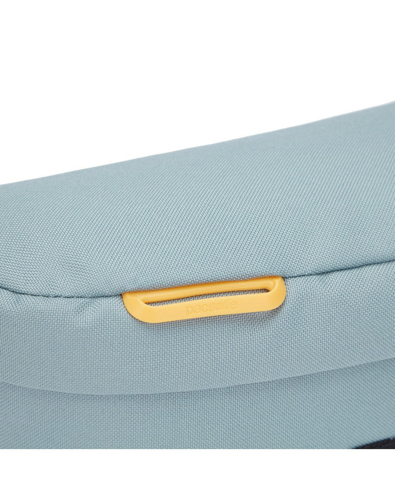 Pacsafe® GO Anti-Theft Sling Pack in fresh mint colour, close up of external attachment point for small items.