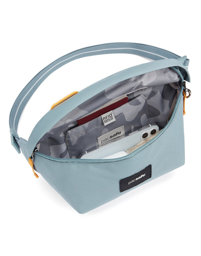 Pacsafe® GO Anti-Theft Sling Pack in fresh mint colour interior view showing a RFID blocking pocket.