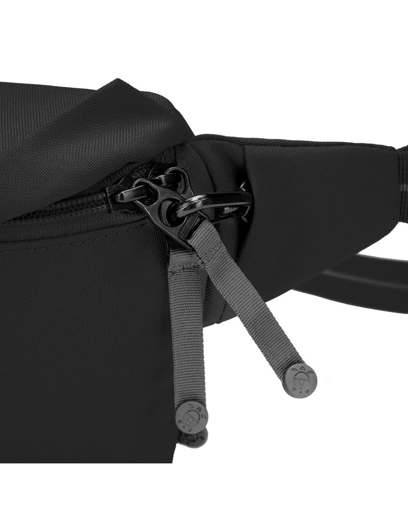 Pacsafe® GO Anti-Theft Sling Pack in jet black colour close up view of the zipper tabs attached to the security clip.