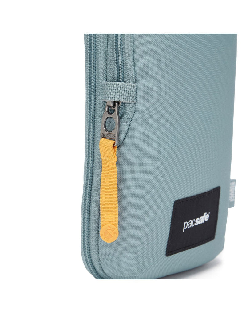 Pacsafe® GO Anti-Theft Tech Crossbody in fresh mint colour close up of the secure zip tab.
