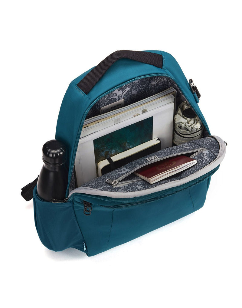 Pacsafe LS350 Anti-Theft 15L Backpack, tidal teal, inside view with books, umbrella, and umbrella inside and water bottle in side slip pocket