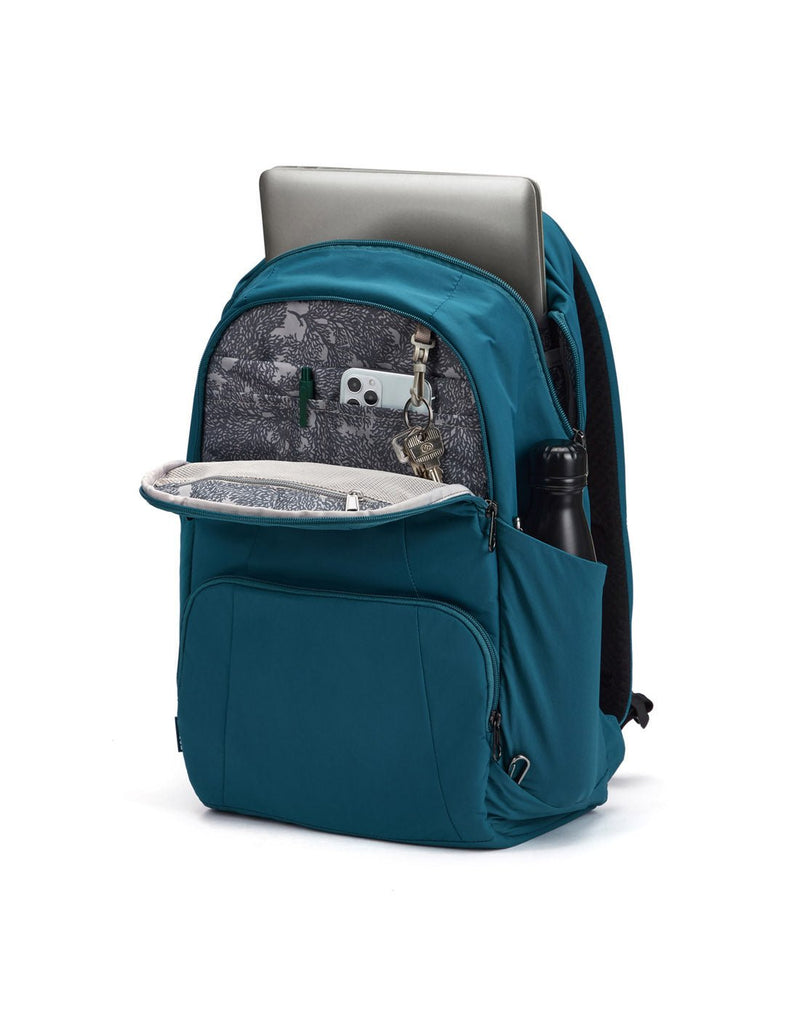 Pacsafe® LS450 Anti-Theft 25L Backpack, tidal teal, unzippered with laptop sticking out of main compartment, pen, phone and keys in front pocket and water bottle in side slip pocket