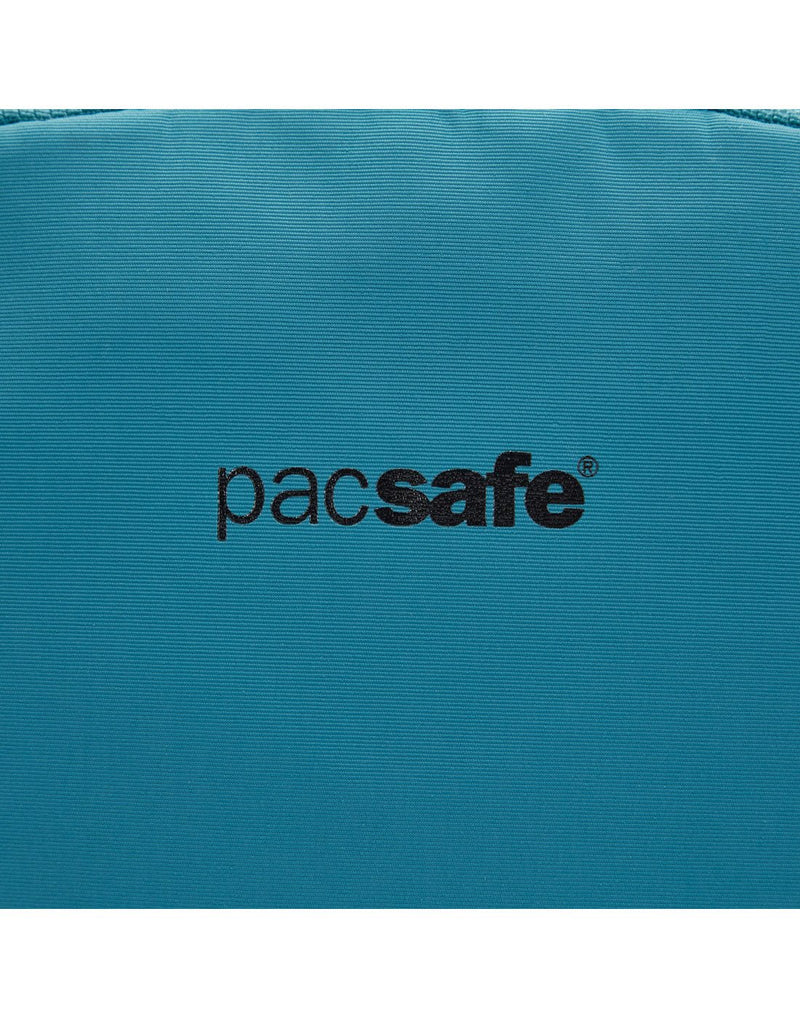 Close up of Pacsafe logo in black on the tidal teal backpack