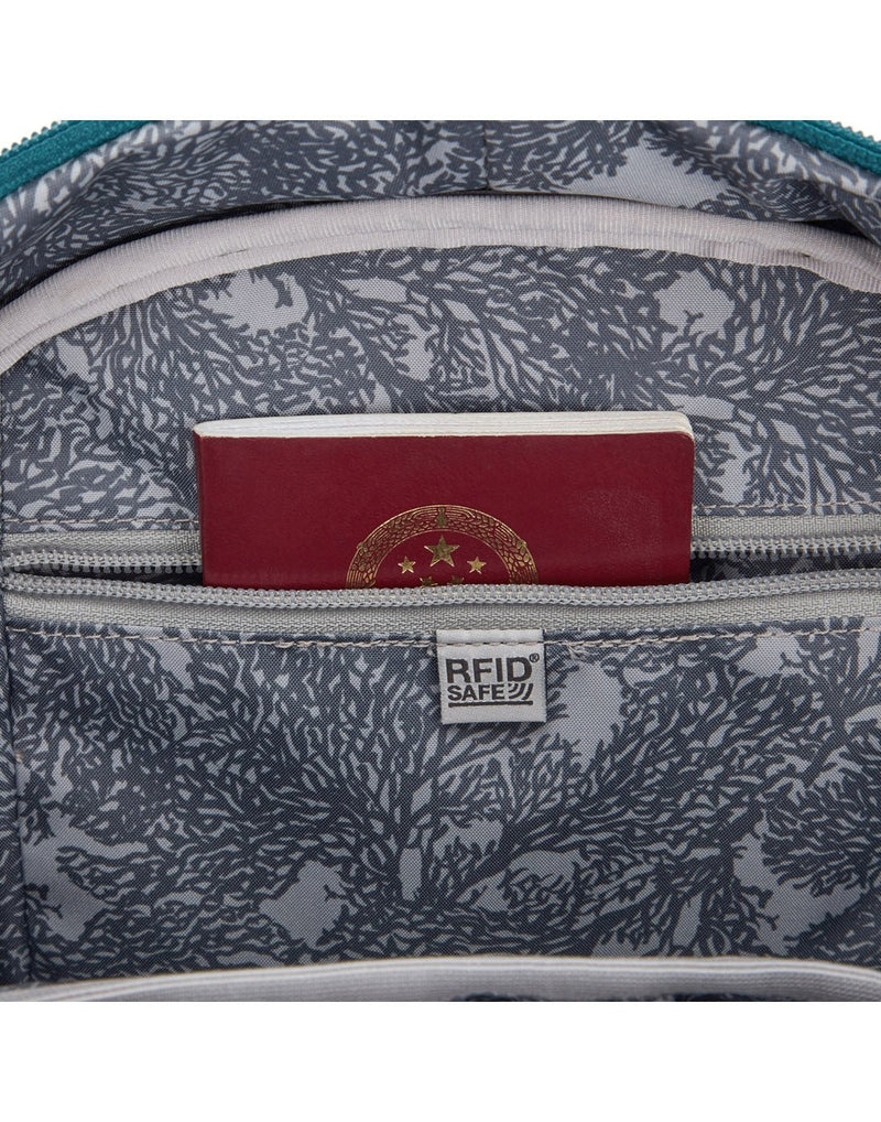 Close up of a passport sticking out of the RFID protected zippered pocket