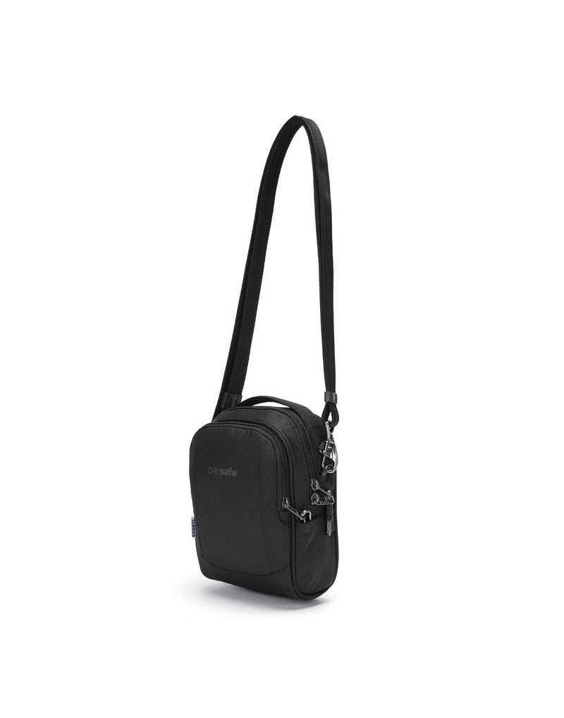 Pacsafe metrosafe ls100 econyl black colour recycled crossbody bag front angled view with strap fully extended