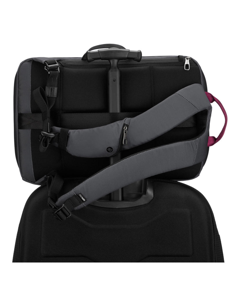 Pacsafe Metrosafe X Anti-Theft 16-Inch Commuter Backpack, slate, on its side with a luggage handle through the back slot
