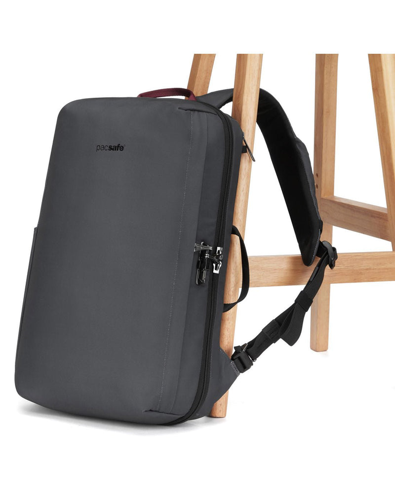 Pacsafe Metrosafe X Anti-Theft 16-Inch Commuter Backpack, slate, with one strap secured to a chair leg