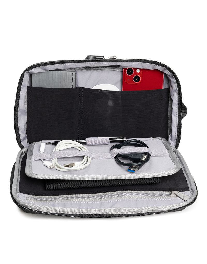Pacsafe RFIDsafe™ RFID Blocking Gadget Pouch, inside view filled with cords, pen, phone and other electronic devices