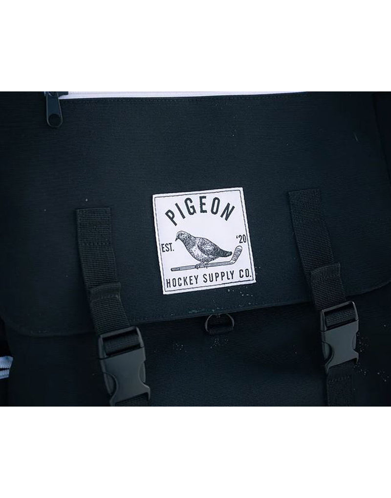 Close up of Pigeon Pack logo and buckle straps