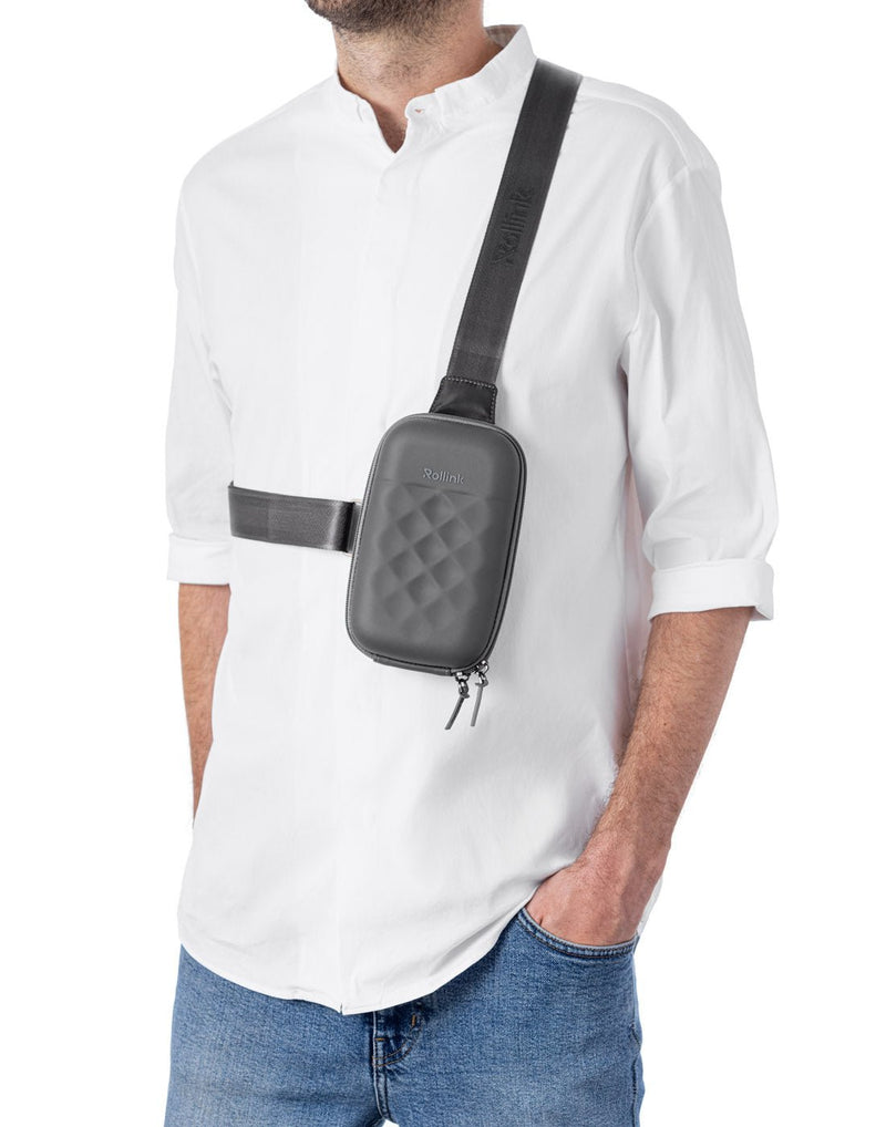 Man wearing the Rollink Mini Bag Go in Iron grey colour as a crossbody bag.