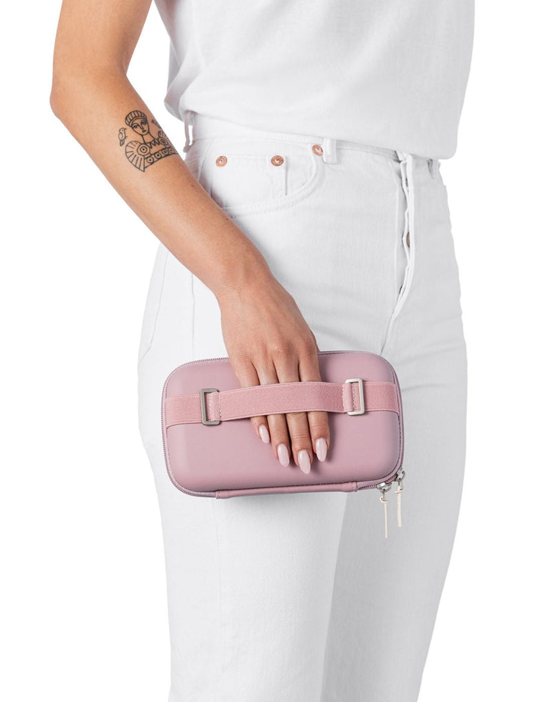Woman holding the Rollink Mini Bag Tour in Lavender with the back hand strap