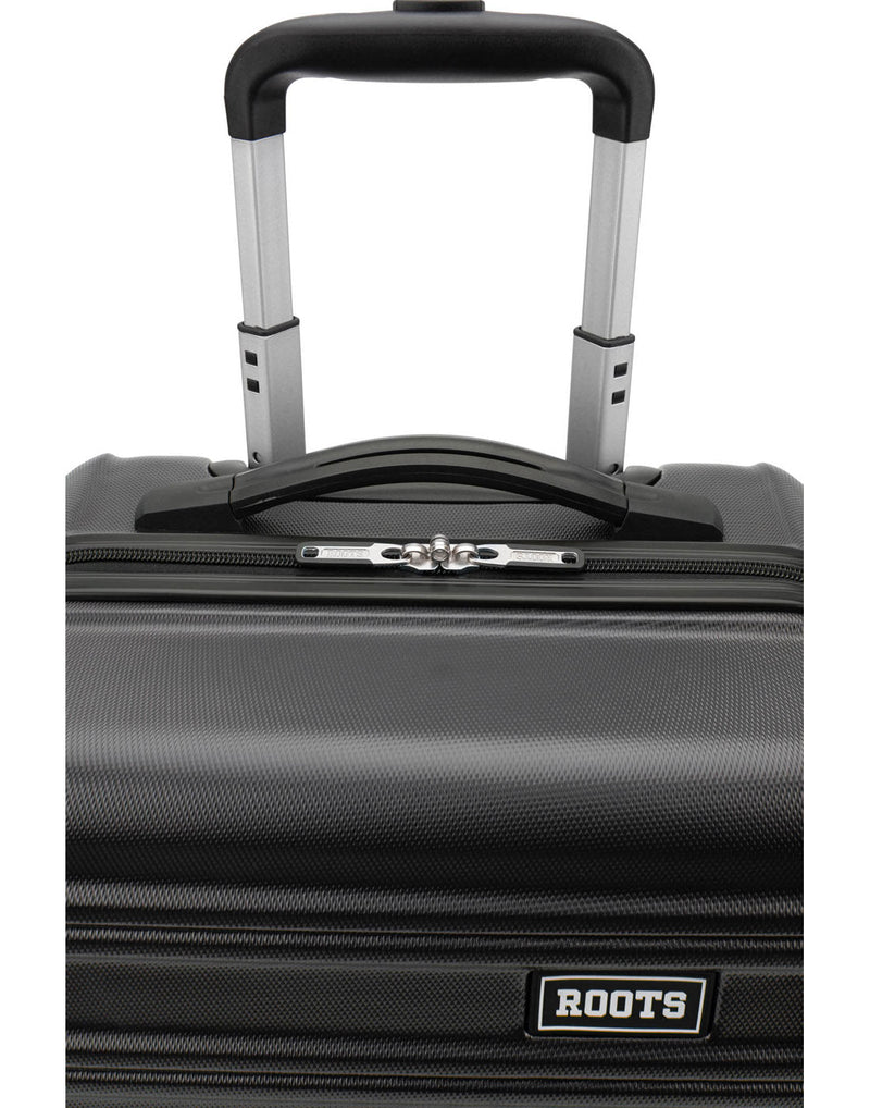 Close up of top grab handle and telescopic handle on charcoal luggage