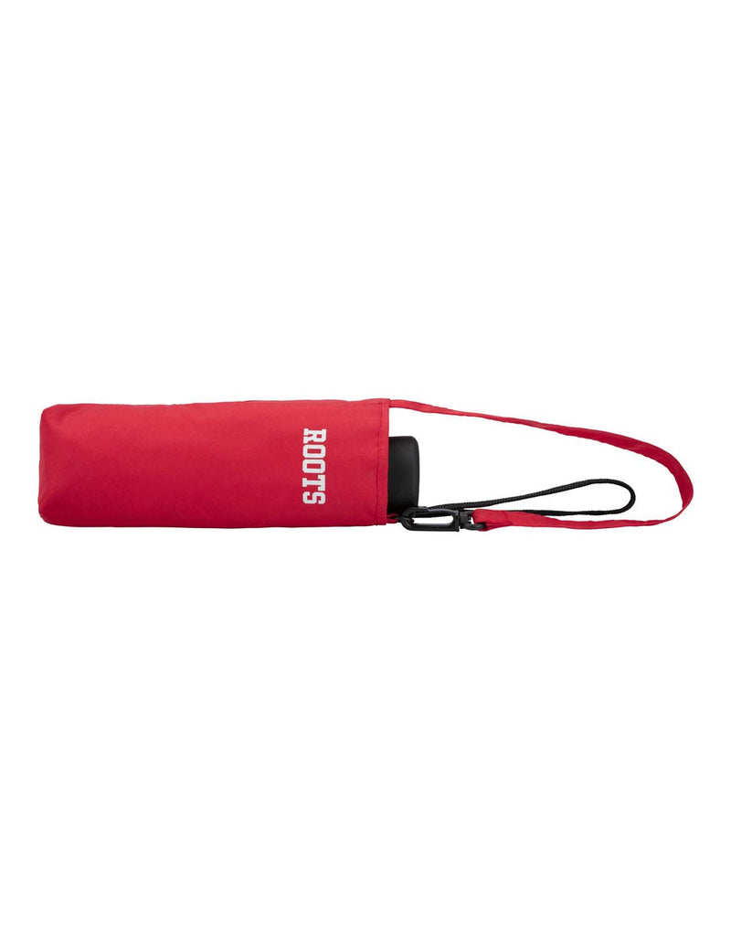 Roots Ultralight Mini Umbrella in red, closed in self-fabric pouch with white Roots logo on side