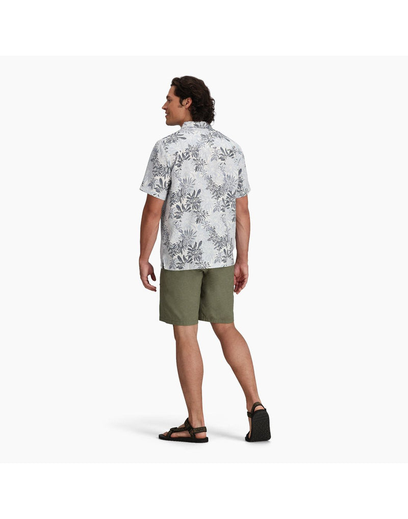 Back view of man wearing Royal Robbins Men's Comino Leaf Short Sleeve with green shorts and black sandals