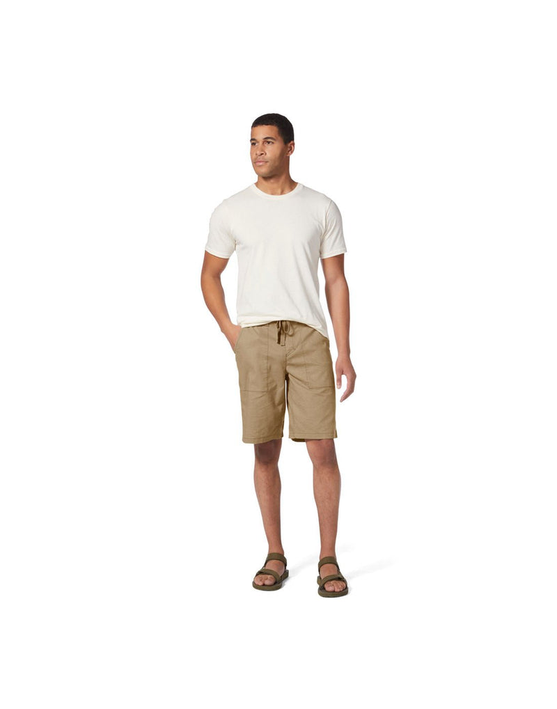 Man wearing white t-shirt, sandals and Royal Robbins Men's Hempline Short in true khaki, front view with right hand in pocket