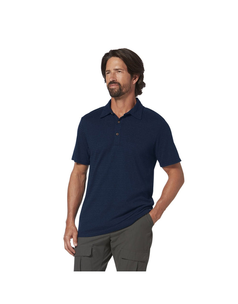 Top half of man wearing Royal Robbins Men's Vacationer Polo in Naval blue colour with charcoal shorts