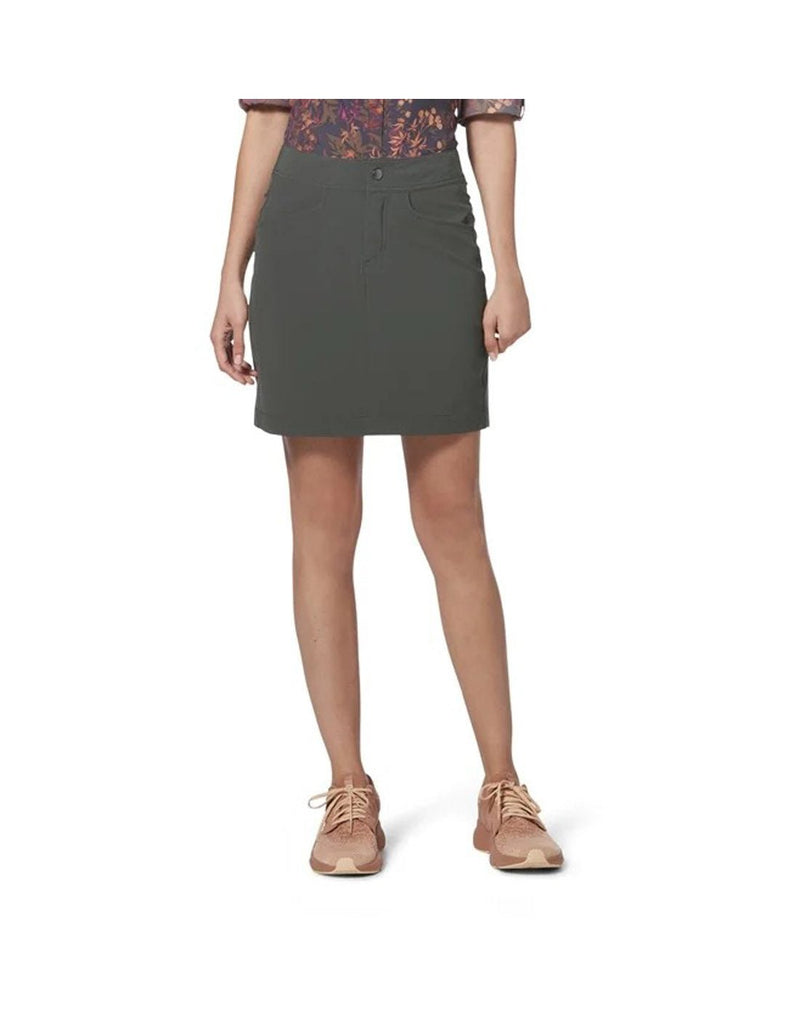 Bottom half of woman wearing Royal Robbins Women's Alpine Mountain Pro Skort in asphalt grey colour, with floral top tucked in and beige running shoes