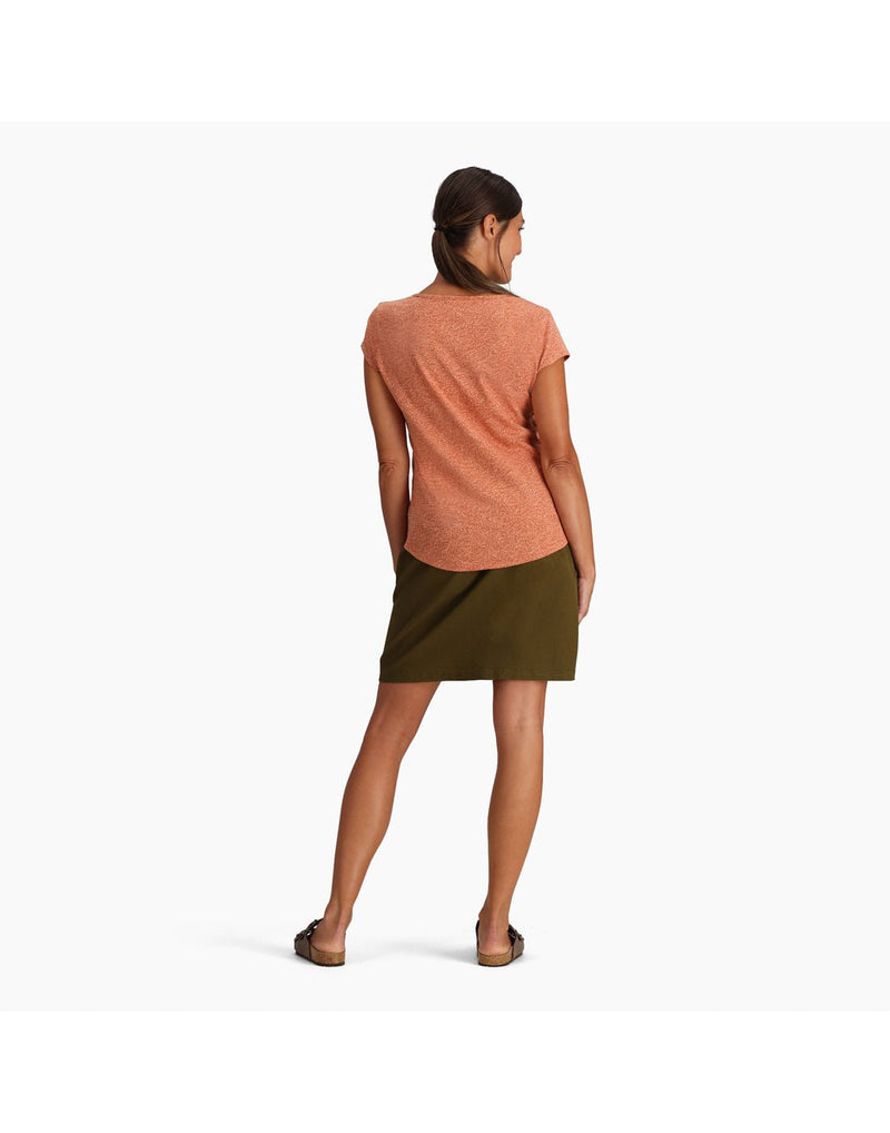 Woman wearing Royal Robbins Women's Featherweight Slub Tee in baked clay with green skirt and sandals, back view