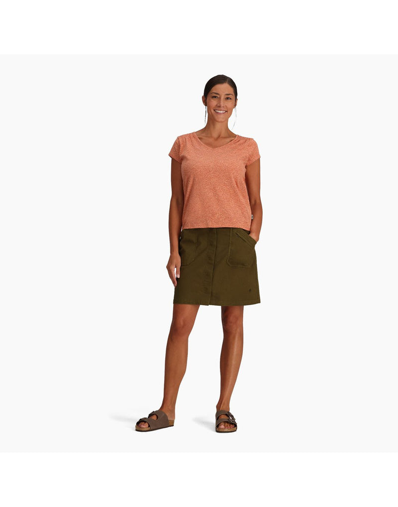 Woman wearing Royal Robbins Women's Featherweight Slub Tee in baked clay with green skirt and sandals, front view