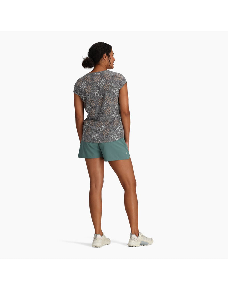 Woman wearing Royal Robbins Women's Featherweight Tee in turbulence usla print with teal shorts and running shoes, back view