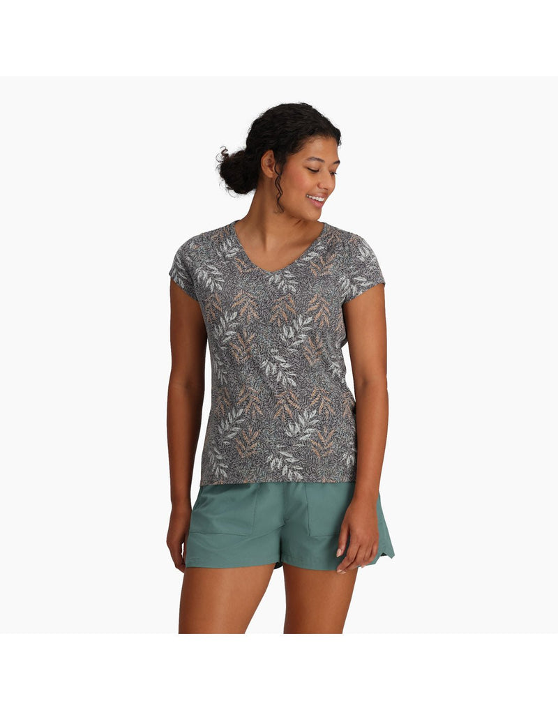 Top half of woman wearing Royal Robbins Women's Featherweight Tee in turbulence usla print with teal shorts front view