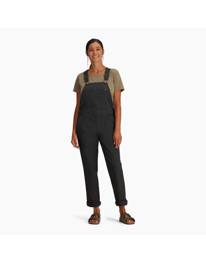 Woman wearing Royal Robbins Women's Half Dome Overall in charcoal grey over a khaki t-shirt.  Bottom of pants are rolled up and she is wearing sandals, front view
