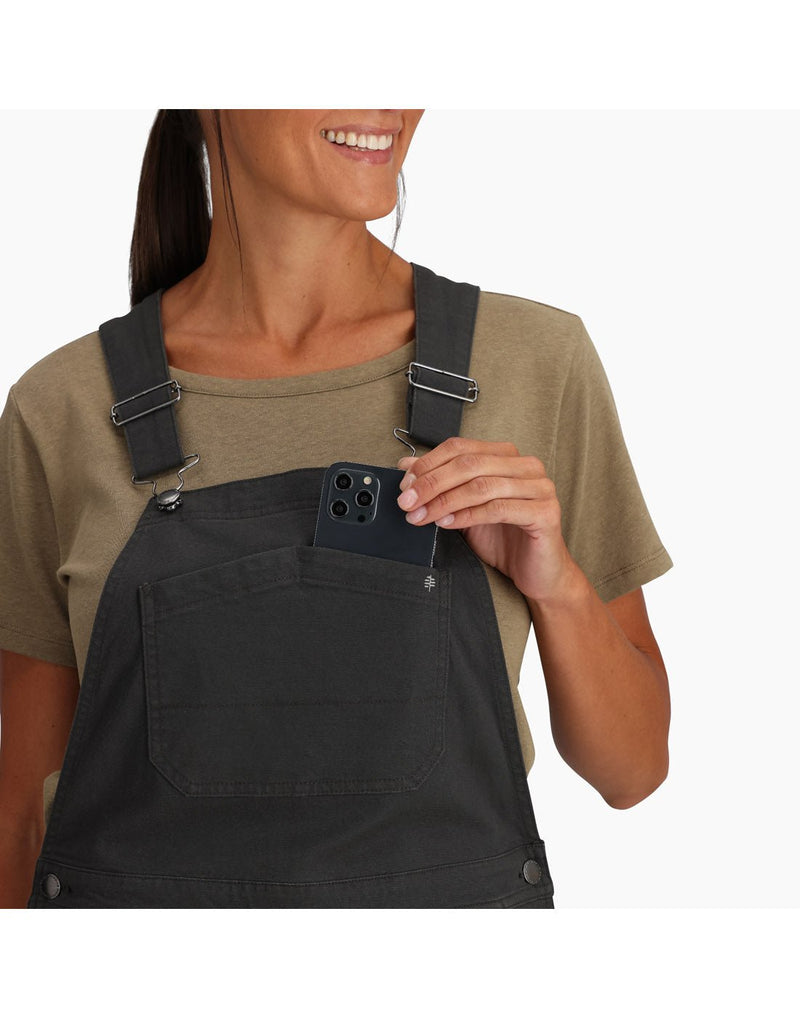 Close up of top of overalls in charcoal, woman taking a phone out of front chest pocket