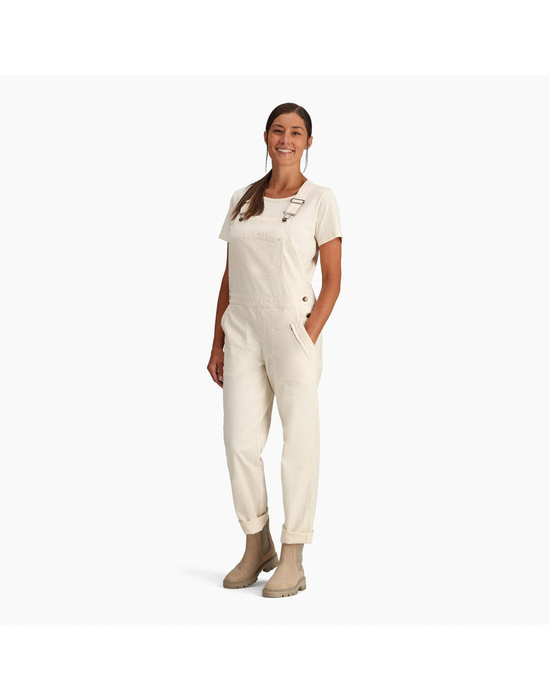 Woman wearing Royal Robbins Women's Half Dome Overall in undyed white over a white t-shirt, side view