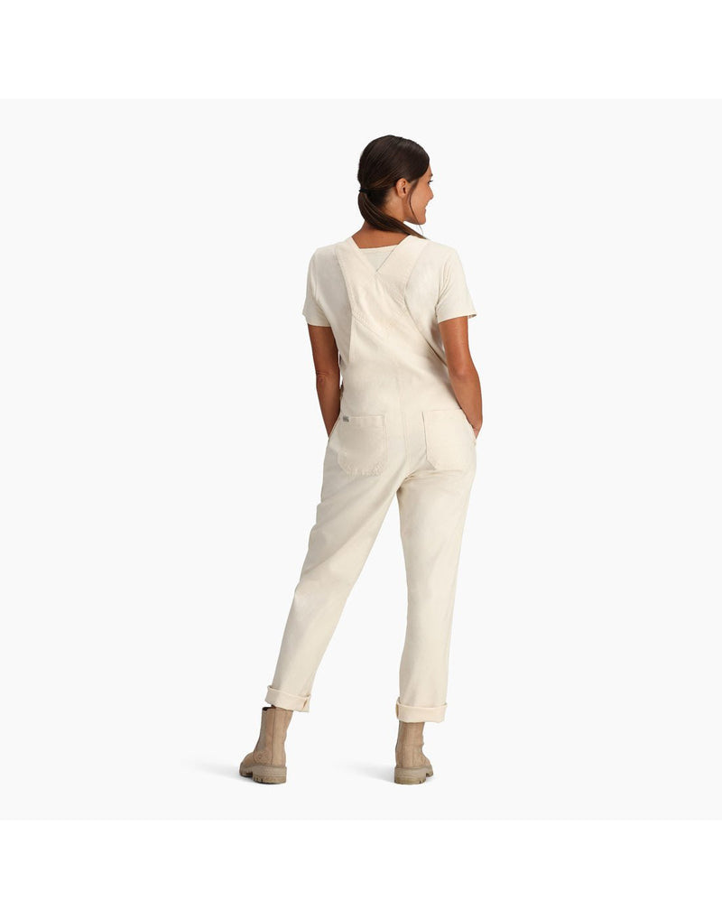 Woman wearing Royal Robbins Women's Half Dome Overall in undyed white over a white t-shirt, back view