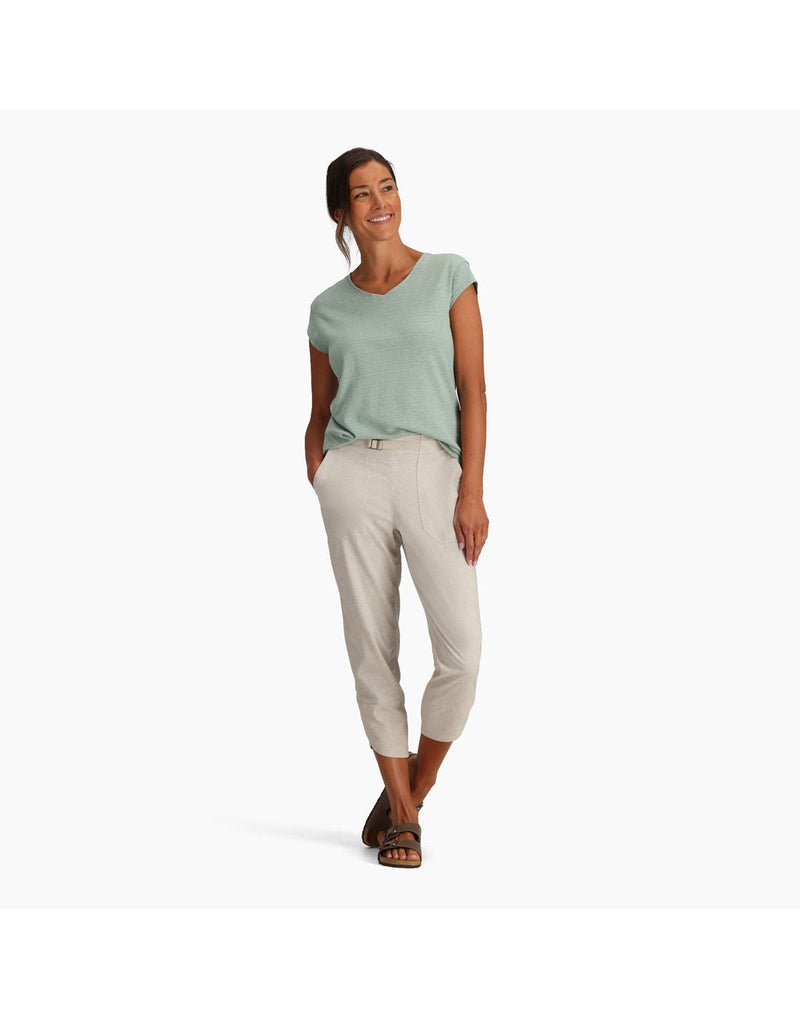Woman wearing Royal Robbins Women's Hempline Capri in blended undyed, off-white colour with mint green t-shirt tucked in and brown sandals, front view