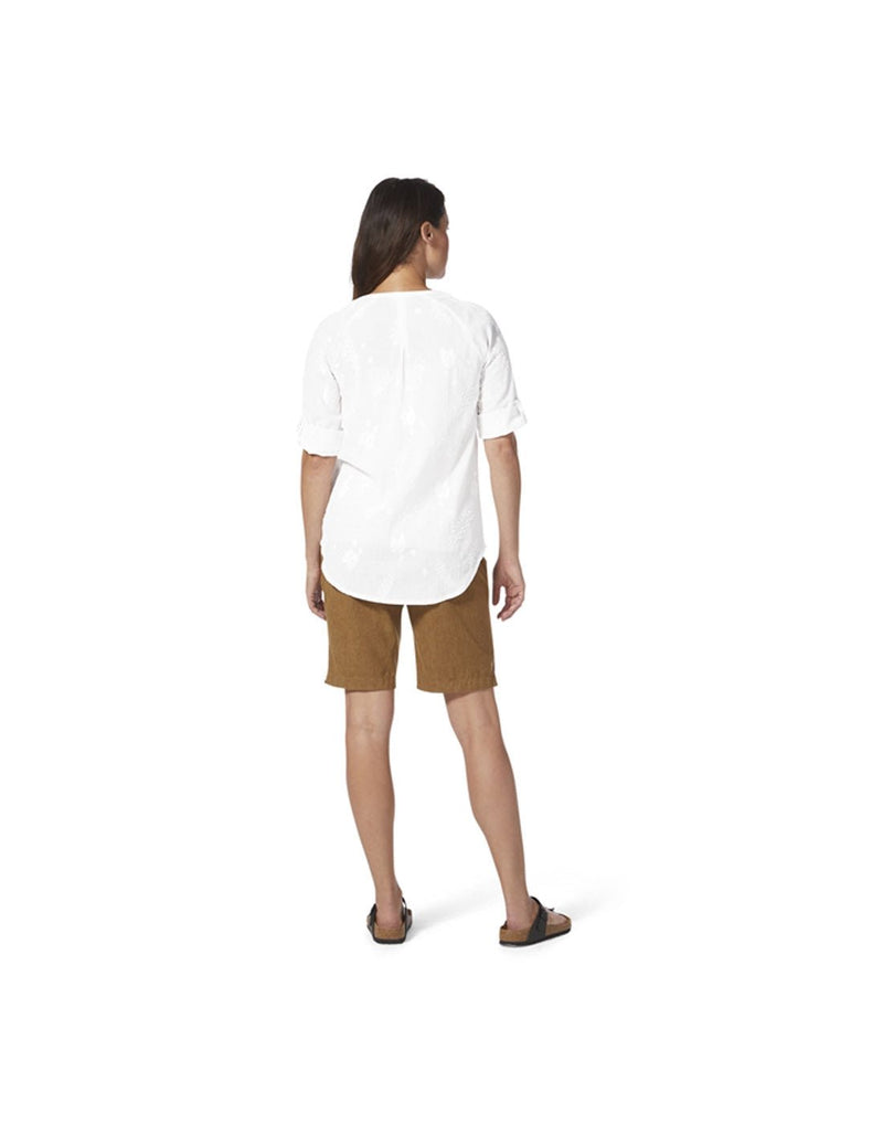 Woman wearing Royal Robbins Women's Oasis Tunic II 3/4 Sleeve in white with brown pants, back view