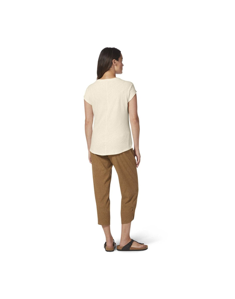 Woman wearing Royal Robbins Women's Vacationer V-Neck Short Sleeve in undyed, off-white colour with brown pants, back view