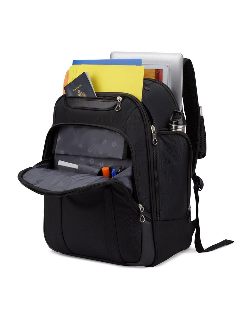Swiss Gear Computer Backpack, black, front angled view with all pockets open, filled with files, passport, laptop, pens, and water bottle
